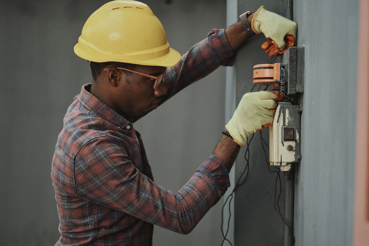 Plumber working on pipes in a Milpitas home